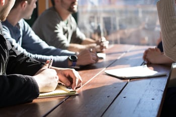 four people sitting at a table