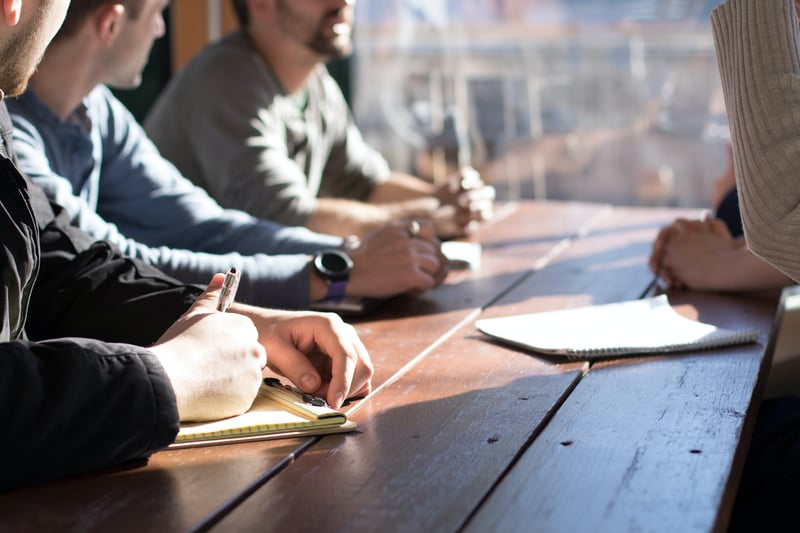 four people sitting at a table