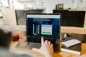 Business professional analyzing laptop screen