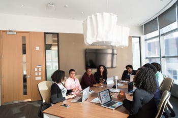 People sitting around a table at a meeting